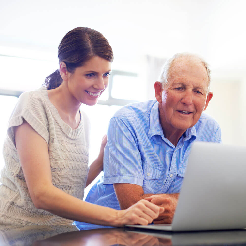 Father and daughter researching home care websites